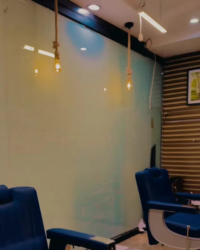 A navy barber chair facing the mirror