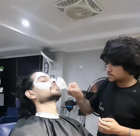 Face polish being applied to a client in the chair