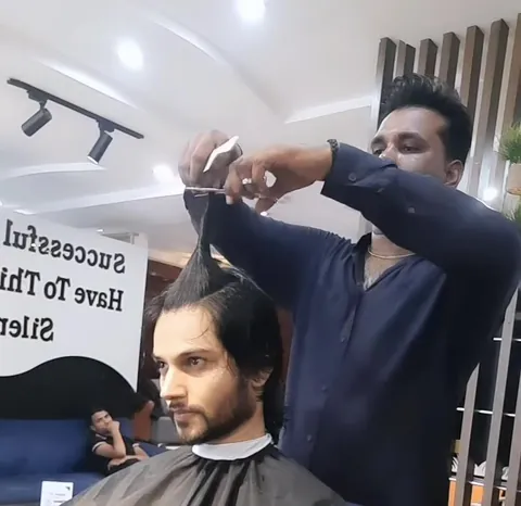 A barber cutting a client's hair at Sultans Salon