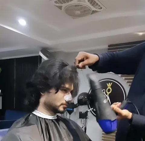 A client's hair being blow-dried and styled