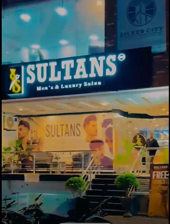 The Sultans Salon shop front at Civic Centre, with its lit sign above the steps